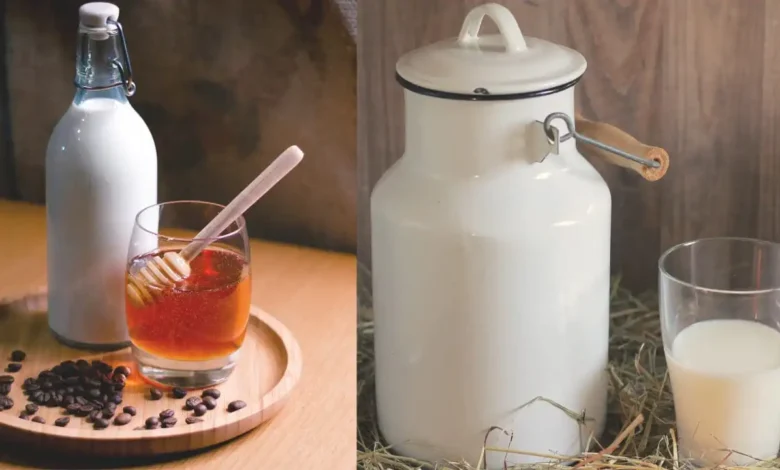 Traditional cow milk containers and glasses with honey and coffee beans on a wooden surface.